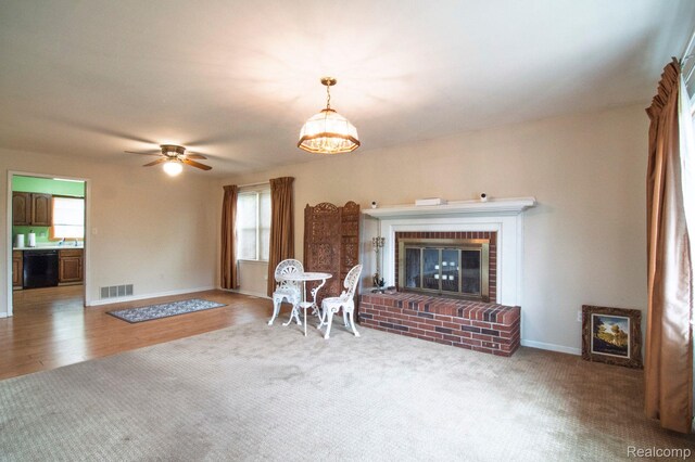 3266 Benstein Rd, Commerce Twp, MI 48382 - living room featuring plenty of natural light, a brick fireplace, baseboards, and ceiling fan