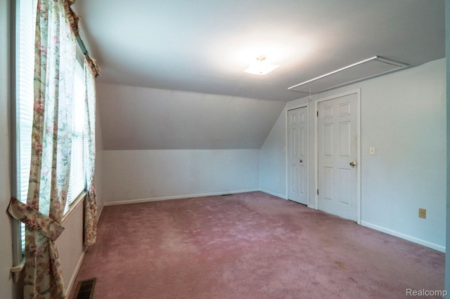 3266 Benstein Rd, Commerce Twp, MI 48382 - additional living space with attic access, carpet, vaulted ceiling, and baseboards