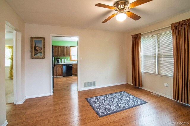 3266 Benstein Rd, Commerce Twp, MI 48382 - spare room featuring light wood-style flooring, a ceiling fan, and baseboards