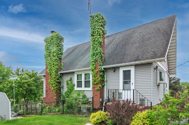 3266 Benstein Rd, Commerce Twp, MI 48382 - rear view of property with a chimney and a shingled roof