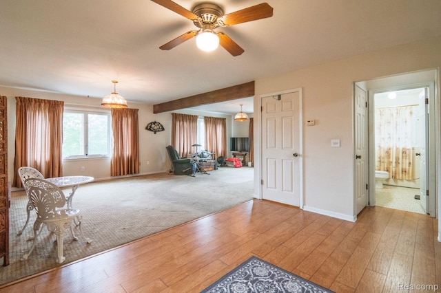 3266 Benstein Rd, Commerce Twp, MI 48382 - living area with baseboards, wood finished floors, a ceiling fan, and carpet floors