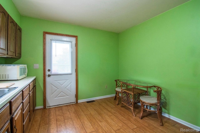 3266 Benstein Rd, Commerce Twp, MI 48382 - dining space featuring light wood-style floors and baseboards