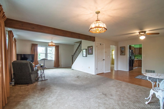 3266 Benstein Rd, Commerce Twp, MI 48382 - living room featuring stairs, a chandelier, baseboards, carpet, and a ceiling fan