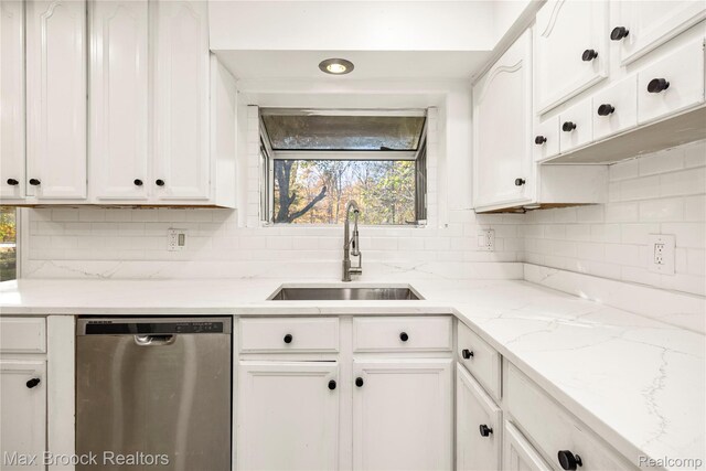 28290 Inkster Rd, Southfield, MI 48034 - kitchen with stainless steel dishwasher, a sink, white cabinetry, and backsplash