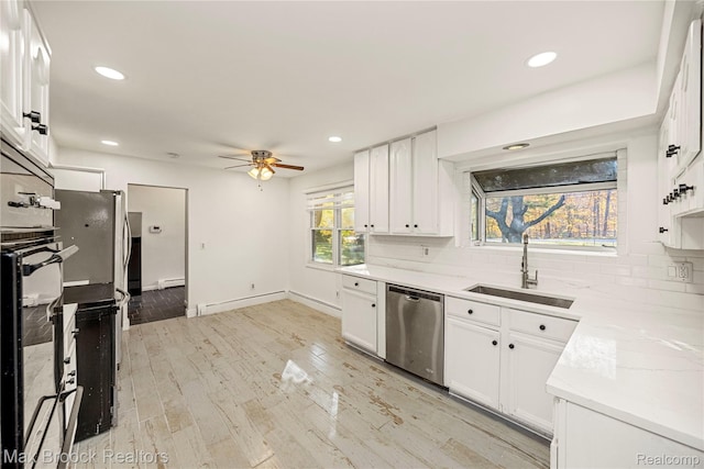 28290 Inkster Rd, Southfield, MI 48034 - kitchen with stainless steel dishwasher, tasteful backsplash, baseboard heating, a ceiling fan, and a sink