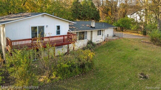 28290 Inkster Rd, Southfield, MI 48034 - back of house featuring a wooden deck, roof with shingles, and a chimney