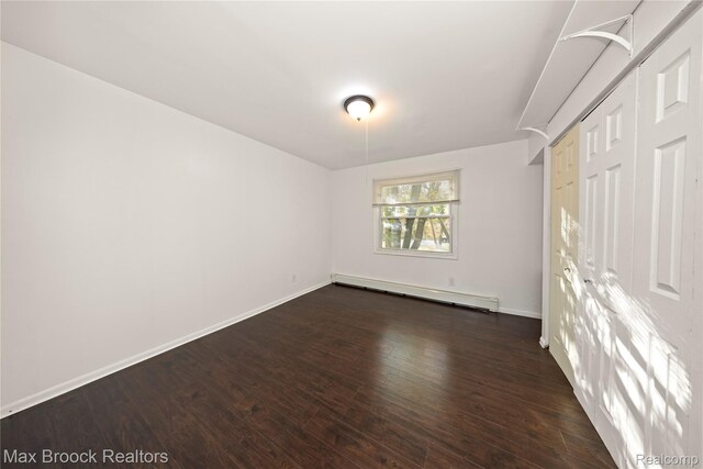 28290 Inkster Rd, Southfield, MI 48034 - unfurnished bedroom with baseboard heating, dark wood-type flooring, and baseboards