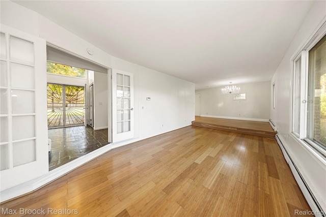 28290 Inkster Rd, Southfield, MI 48034 - spare room with a chandelier, a baseboard radiator, light wood-style floors, and baseboards