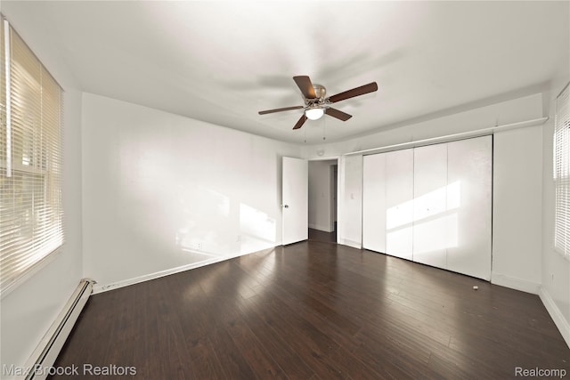 28290 Inkster Rd, Southfield, MI 48034 - unfurnished bedroom featuring a baseboard heating unit, a closet, wood finished floors, and baseboards