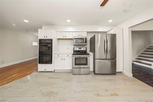28290 Inkster Rd, Southfield, MI 48034 - kitchen with stainless steel appliances, baseboards, light wood-type flooring, white cabinetry, and recessed lighting