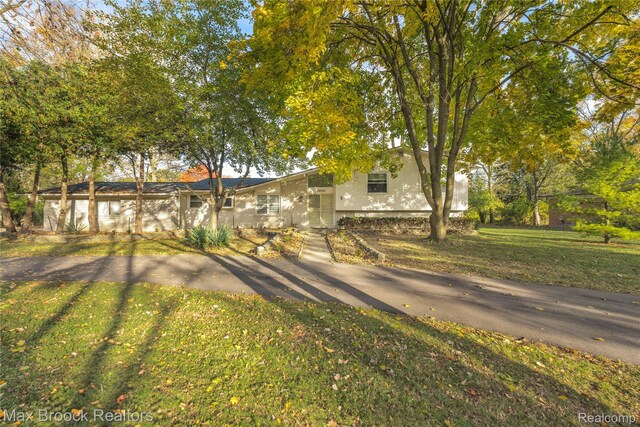 28290 Inkster Rd, Southfield, MI 48034 - view of front of home with a front lawn and stucco siding