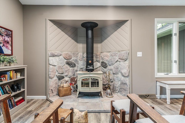 5400 Laura Dr, Shelbyville, MI 49344 - detailed view of wood finished floors, a wood stove, and baseboards