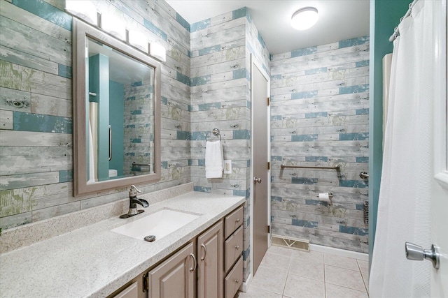 5400 Laura Dr, Shelbyville, MI 49344 - bathroom with vanity, tile patterned floors, and wood walls