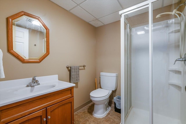 5400 Laura Dr, Shelbyville, MI 49344 - full bath with vanity, toilet, a paneled ceiling, a shower stall, and tile patterned flooring