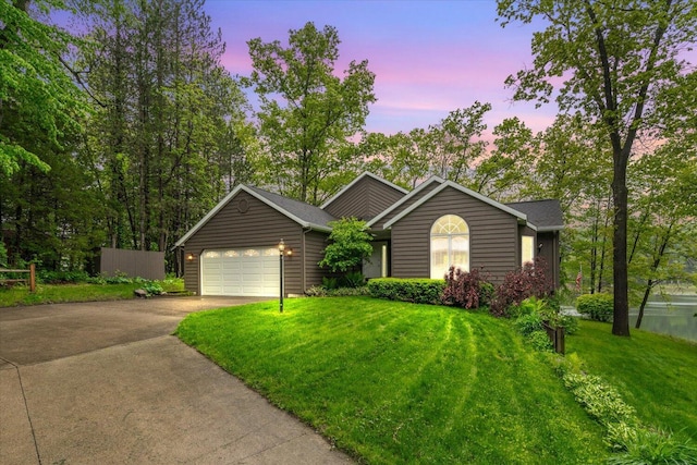 5400 Laura Dr, Shelbyville, MI 49344 - ranch-style house with concrete driveway, an attached garage, and a lawn