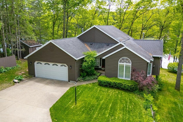 5400 Laura Dr, Shelbyville, MI 49344 - view of front of property featuring a garage, driveway, a front lawn, and roof with shingles