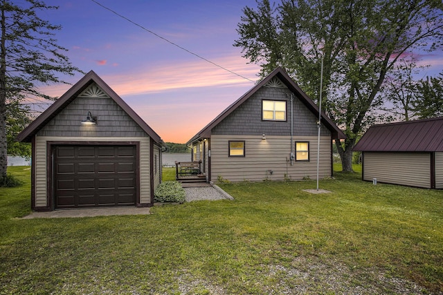 3050 Thorpe Dr, Delton, MI 49046 - rear view of house with an outbuilding, a garage, and a yard