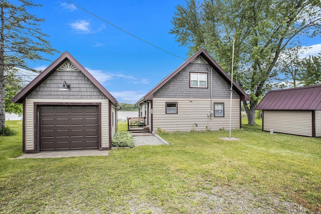 3050 Thorpe Dr, Delton, MI 49046 - rear view of house featuring an outdoor structure, a garage, and a lawn