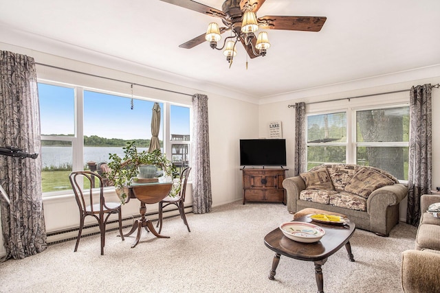 3050 Thorpe Dr, Delton, MI 49046 - living room with ceiling fan, plenty of natural light, ornamental molding, light carpet, and baseboard heating