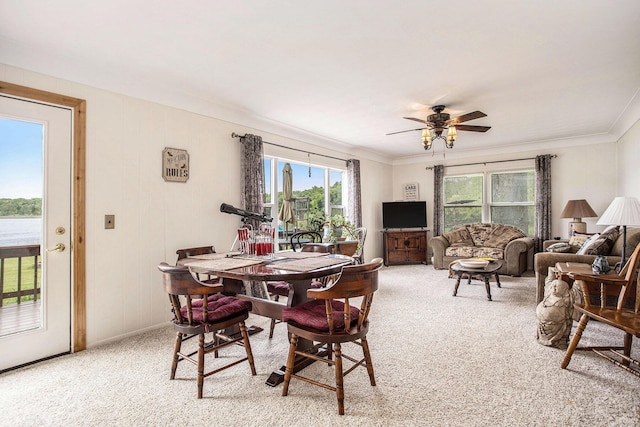 3050 Thorpe Dr, Delton, MI 49046 - dining space featuring carpet flooring, a ceiling fan, and crown molding