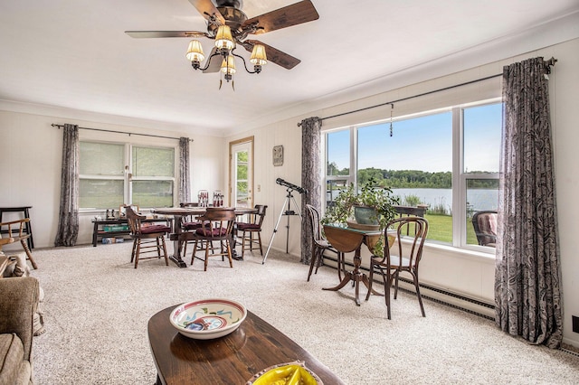 3050 Thorpe Dr, Delton, MI 49046 - dining space with carpet flooring, a water view, a ceiling fan, crown molding, and a baseboard radiator
