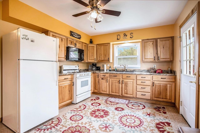 3050 Thorpe Dr, Delton, MI 49046 - kitchen with white appliances, a sink, ceiling fan, and light stone counters