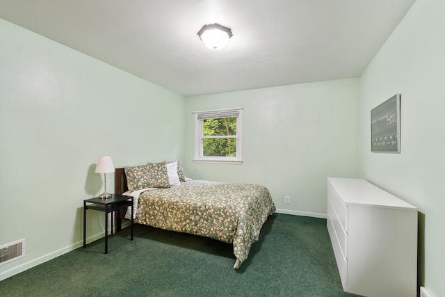 210 E Palmer Ave, Jackson, MI 49203 - bedroom with dark colored carpet and baseboards
