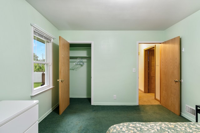 210 E Palmer Ave, Jackson, MI 49203 - unfurnished bedroom with carpet floors, baseboards, and a closet