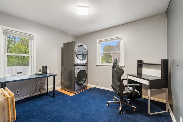 210 E Palmer Ave, Jackson, MI 49203 - home office with stacked washing machine and dryer, carpet flooring, plenty of natural light, and baseboards