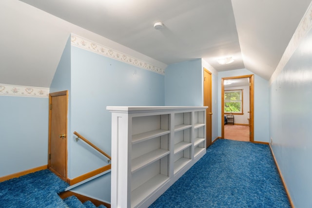 210 E Palmer Ave, Jackson, MI 49203 - hallway with lofted ceiling, baseboards, carpet floors, and an upstairs landing