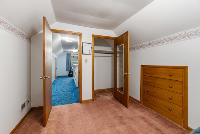 210 E Palmer Ave, Jackson, MI 49203 - carpeted bedroom with lofted ceiling, a closet, and baseboards
