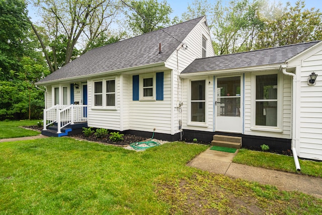 210 E Palmer Ave, Jackson, MI 49203 - view of front facade featuring a shingled roof, a front yard, and entry steps