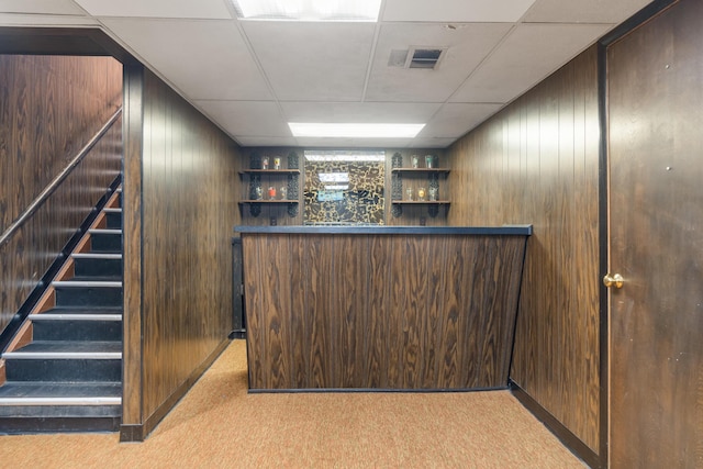 210 E Palmer Ave, Jackson, MI 49203 - indoor dry bar featuring carpet floors, stairway, a paneled ceiling, and wood walls