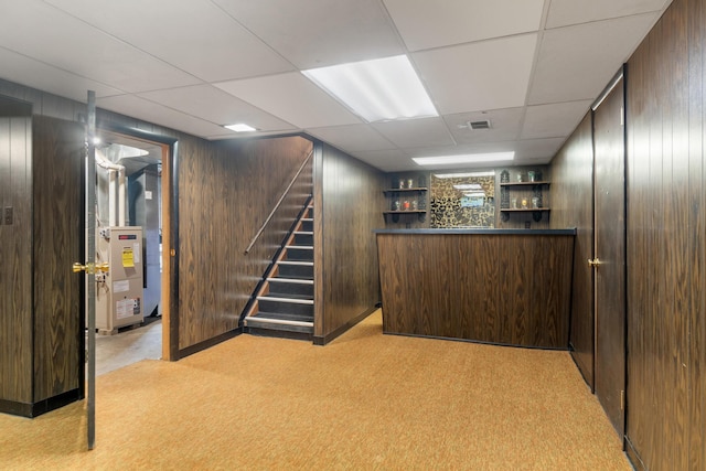 210 E Palmer Ave, Jackson, MI 49203 - finished basement with a bar, stairway, wooden walls, light carpet, and a drop ceiling