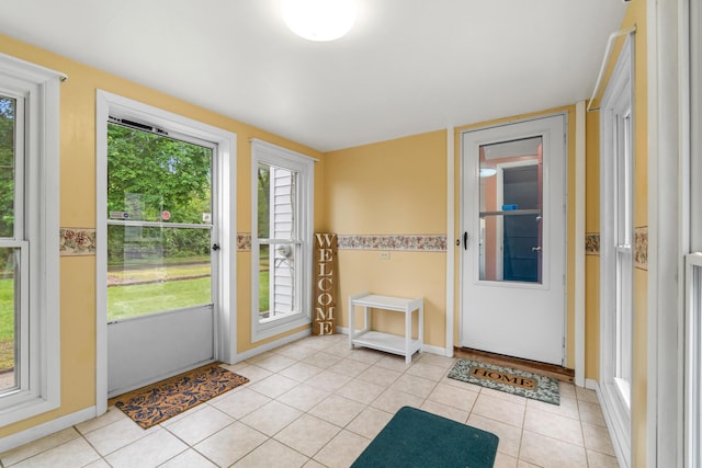 210 E Palmer Ave, Jackson, MI 49203 - doorway with light tile patterned floors and baseboards