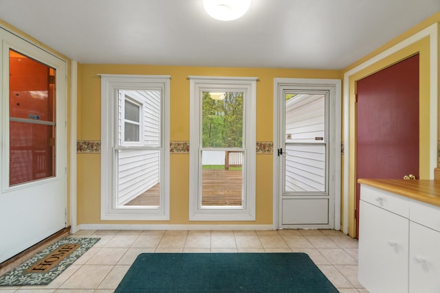 210 E Palmer Ave, Jackson, MI 49203 - doorway with baseboards and light tile patterned floors