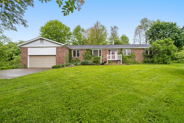 2141 N Parker Rd, Dexter, MI 48130 - single story home with brick siding, a garage, a front yard, and driveway