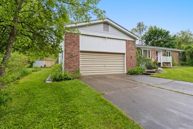 2141 N Parker Rd, Dexter, MI 48130 - single story home featuring asphalt driveway, brick siding, a garage, and a front yard