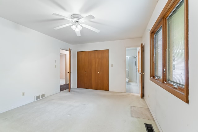 2141 N Parker Rd, Dexter, MI 48130 - unfurnished bedroom featuring light colored carpet, connected bathroom, a closet, and baseboards