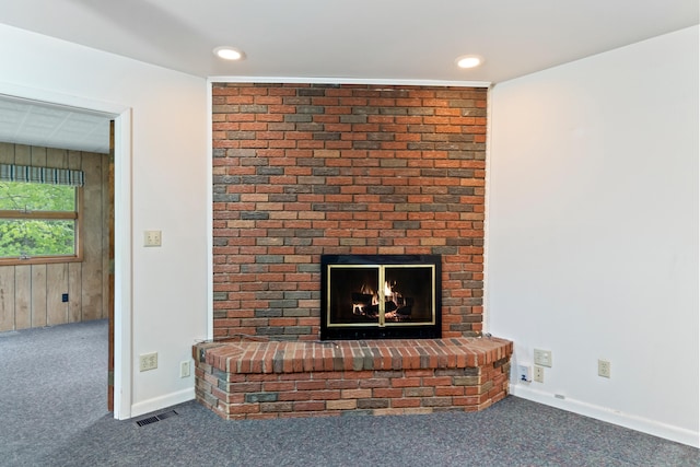 2141 N Parker Rd, Dexter, MI 48130 - detailed view of carpet floors, a brick fireplace, recessed lighting, wooden walls, and baseboards