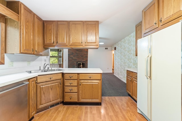 2141 N Parker Rd, Dexter, MI 48130 - kitchen with freestanding refrigerator, dishwasher, a sink, light countertops, and a peninsula