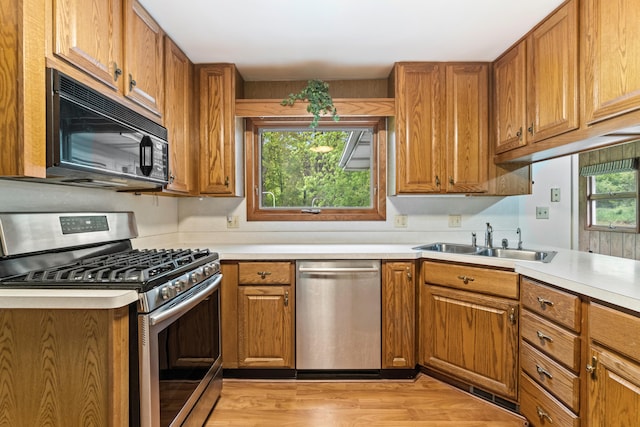 2141 N Parker Rd, Dexter, MI 48130 - kitchen featuring appliances with stainless steel finishes, a sink, and brown cabinetry