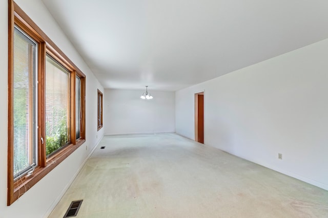 2141 N Parker Rd, Dexter, MI 48130 - empty room featuring a chandelier, light carpet, and baseboards