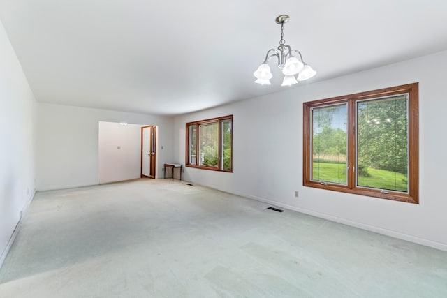 2141 N Parker Rd, Dexter, MI 48130 - spare room with a chandelier, light colored carpet, and baseboards