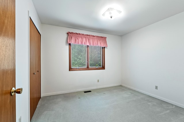 2141 N Parker Rd, Dexter, MI 48130 - unfurnished bedroom with carpet flooring, a closet, and baseboards