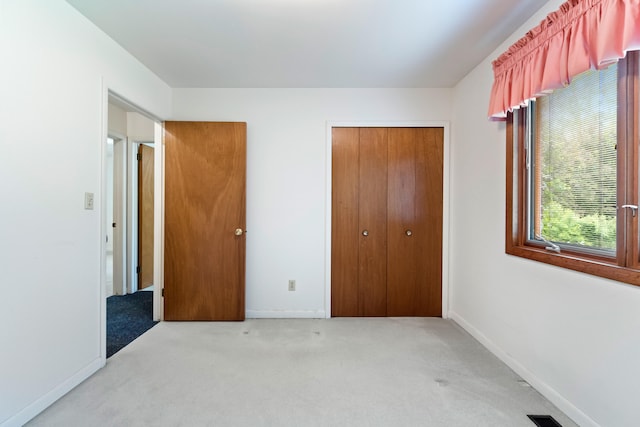 2141 N Parker Rd, Dexter, MI 48130 - unfurnished bedroom with light colored carpet, a closet, and baseboards