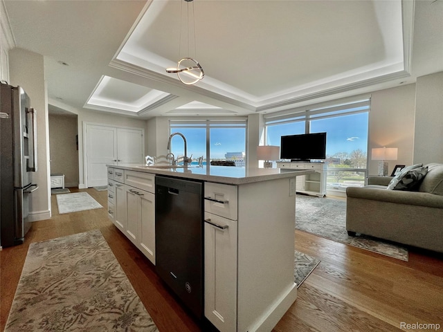 201 Beers St Unit 44, Port Huron, MI 48060 - kitchen featuring freestanding refrigerator, dishwasher, a sink, open floor plan, and white cabinetry