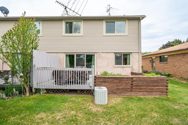 14850 La Grande Plz, Warren, MI 48088 - rear view of house featuring central AC unit, a yard, brick siding, and a wooden deck