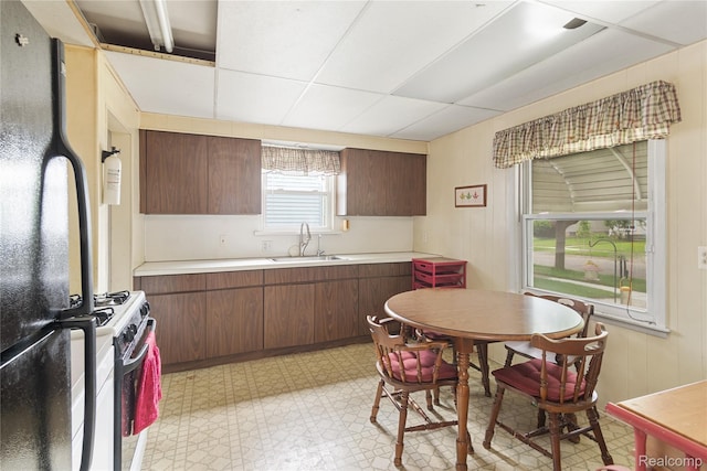 13680 Borgman St, Oak Park, MI 48237 - kitchen featuring freestanding refrigerator, a sink, gas range, light countertops, and light flooring