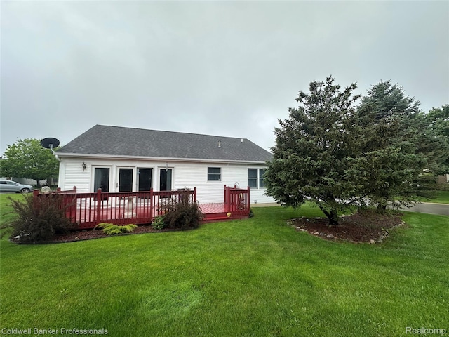 638 Eastway Cir, Lapeer, MI 48446 - rear view of house with a wooden deck, a lawn, and roof with shingles